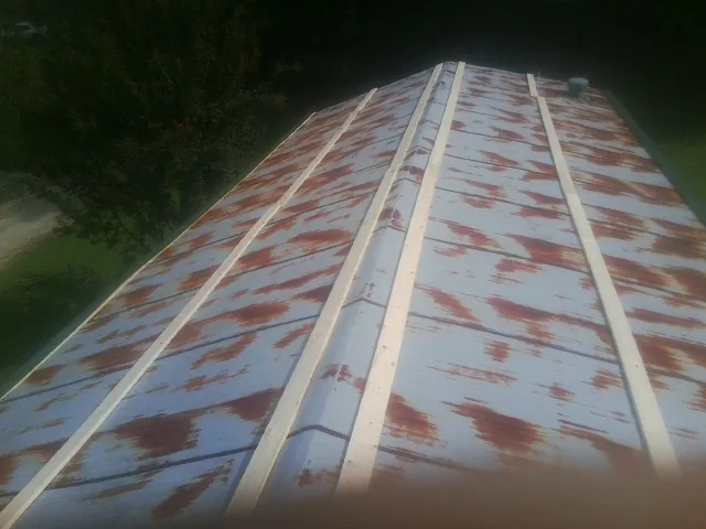 Rusted metal roof panels with new wood purlins before replacement — Storm Damage Roof Repair in Piru by Roofing Brothers